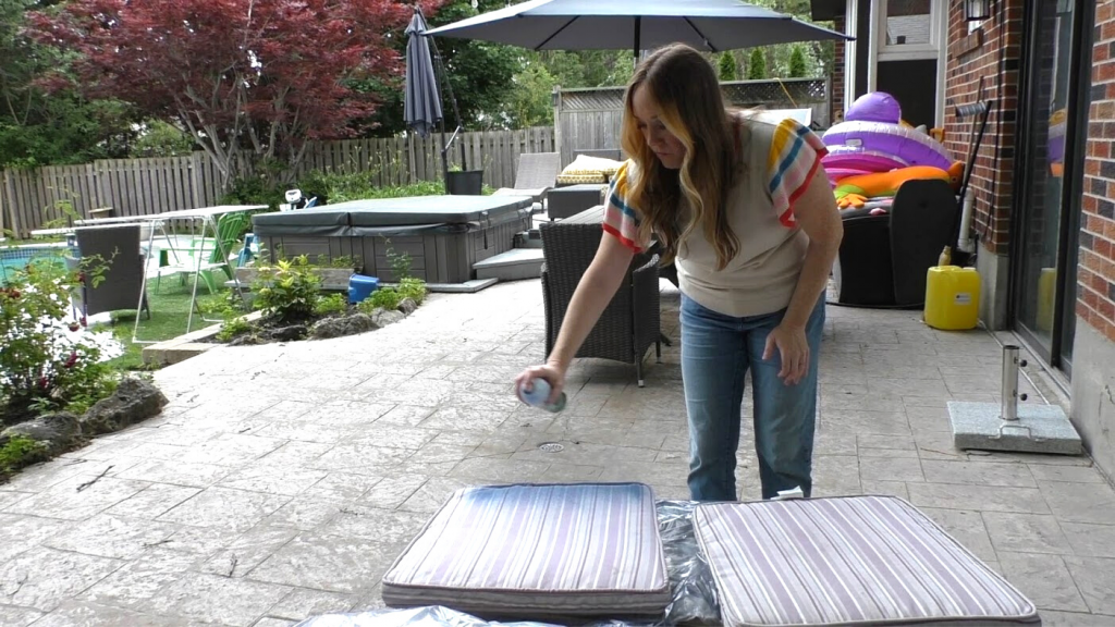 woman spray painting patio cushion