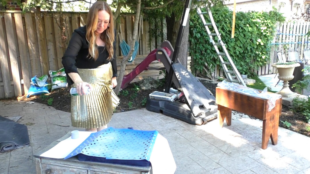 woman using stencil to update patio cushion