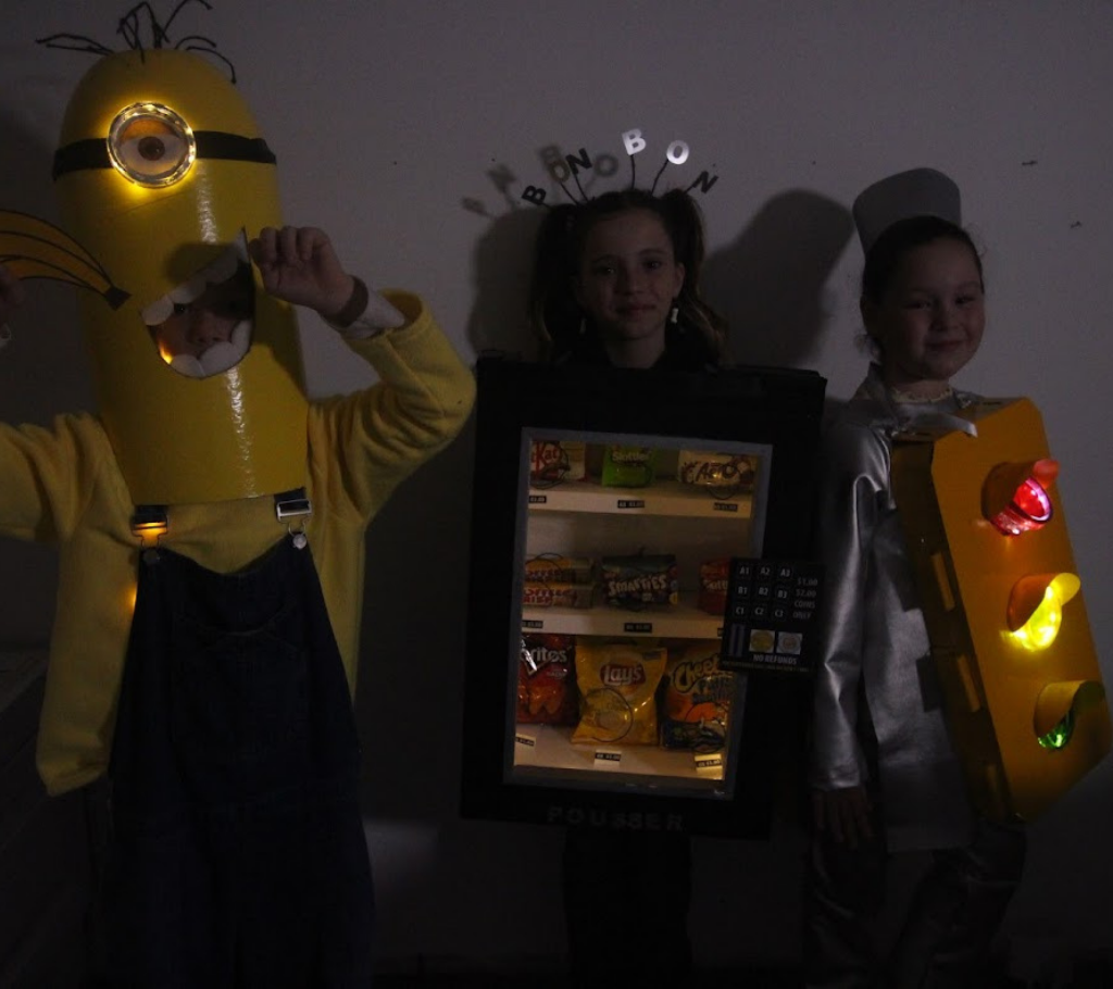 three kids wearing light up Halloween costume