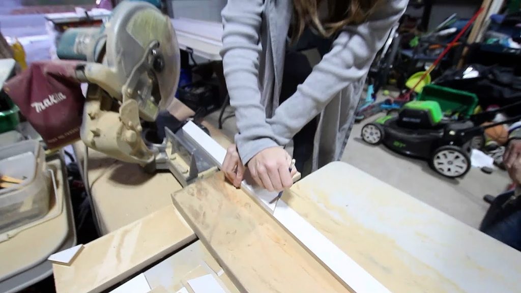 woman making cut line on wood
