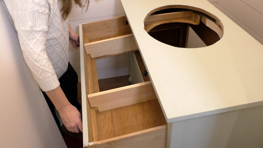 woman pulling out dresser drawers in bathroom